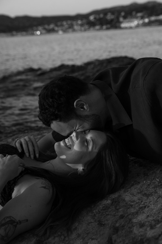 Un couple s’embrasse sur la plage en noir et blanc