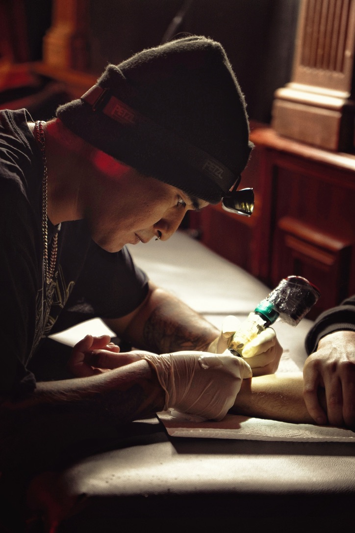 Un tatoueur réalise un motif pendant une session flash