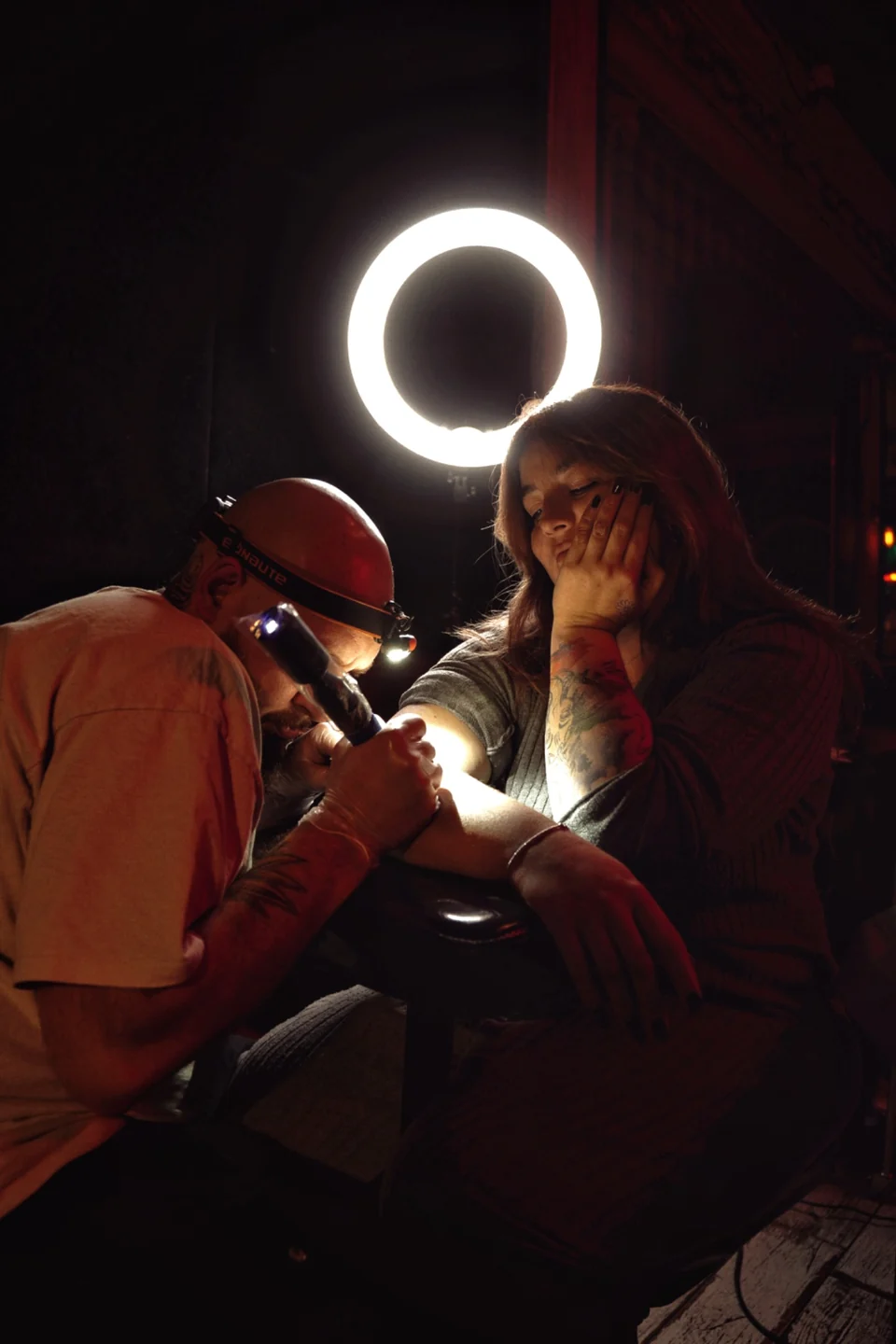 Un tatoueur réalise un flash sur une cliente pendant une soirée tattoo